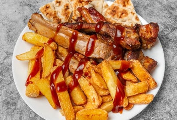 Pork Belly Ribs served with chips pitta bread sallad and tzatziki dip