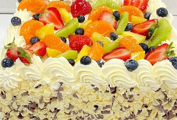 Top Mix Fruit, Milk and White Curls on the Side Square Cake