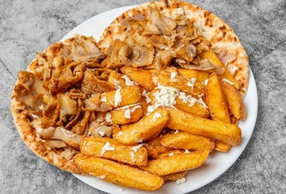 Pork Gyros served with chips pitta bread sallad and tzatziki dip
