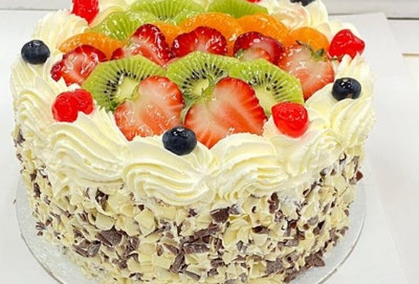 Mix Fruit on the Top, Milk and White Curls on the Side Round Cake