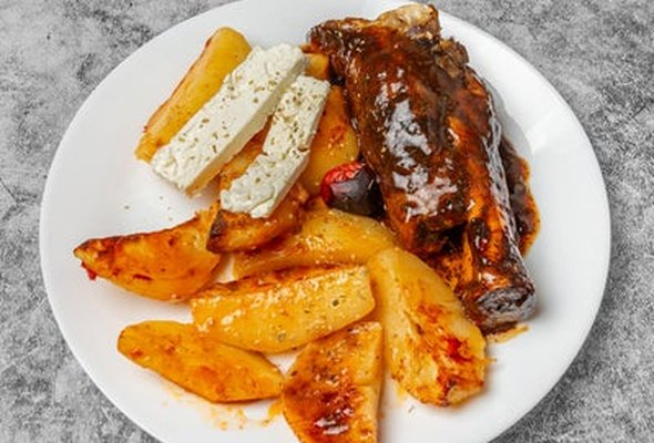 Lamb Kleftiko served with chips pitta bread sallad and tzatziki dip