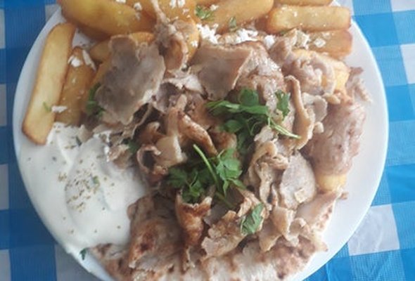Chicken served with chips pitta bread sallad and tzatziki dip