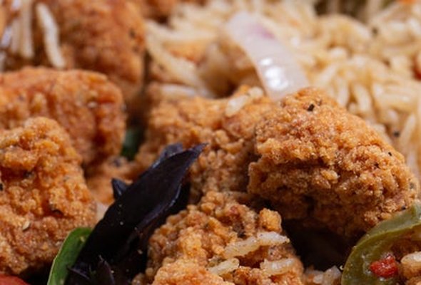 Chicken popcorn Rice Box with a drink.